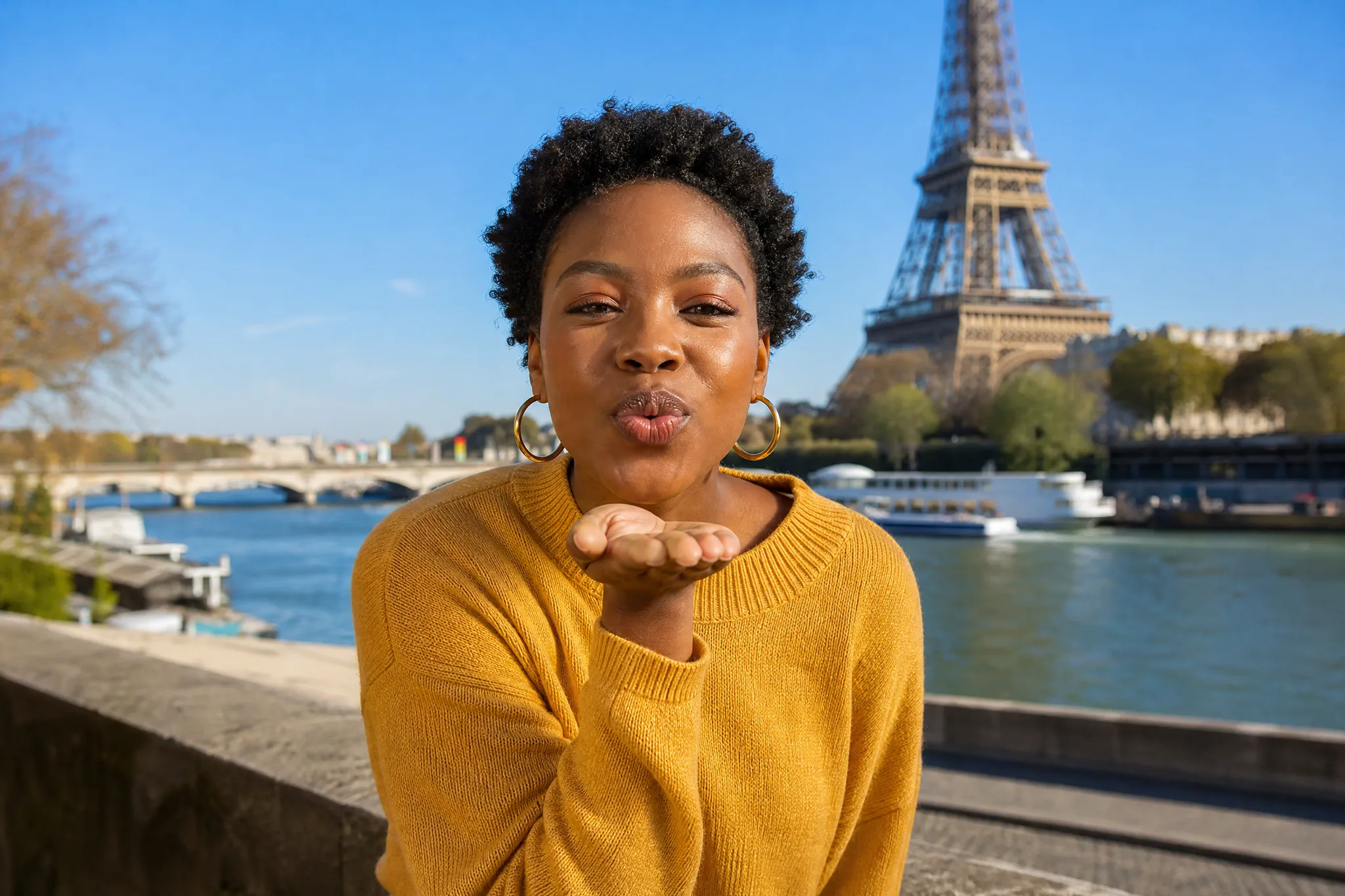 AI kissing generator sample: a woman with short curls blows a kiss from her palm by the Seine, Eiffel Tower behind