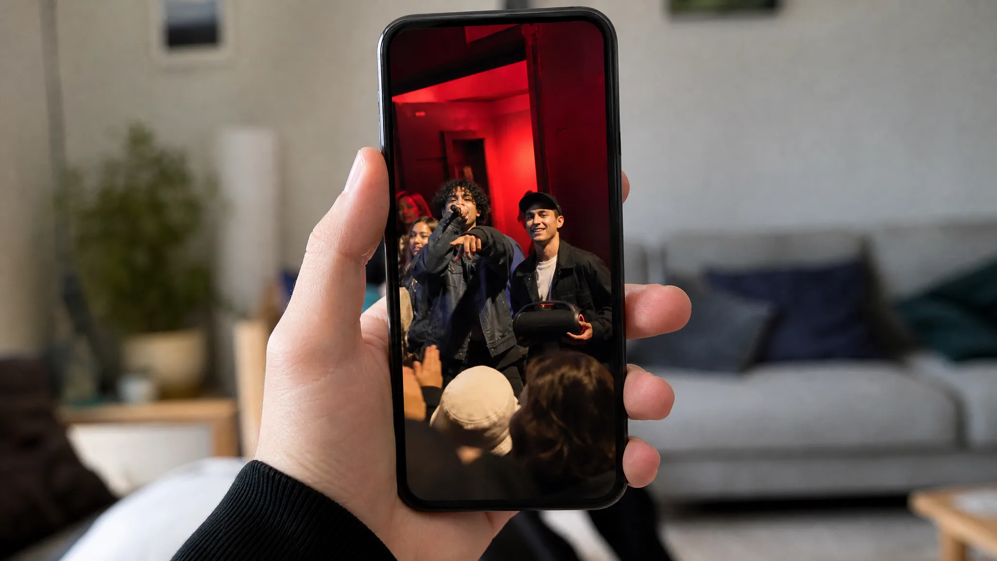 Bulin 47 AI Video Maker: Ready for the Feed Hand holding an upright phone that plays a vertical freestyle clip filmed at a red-lit doorway
