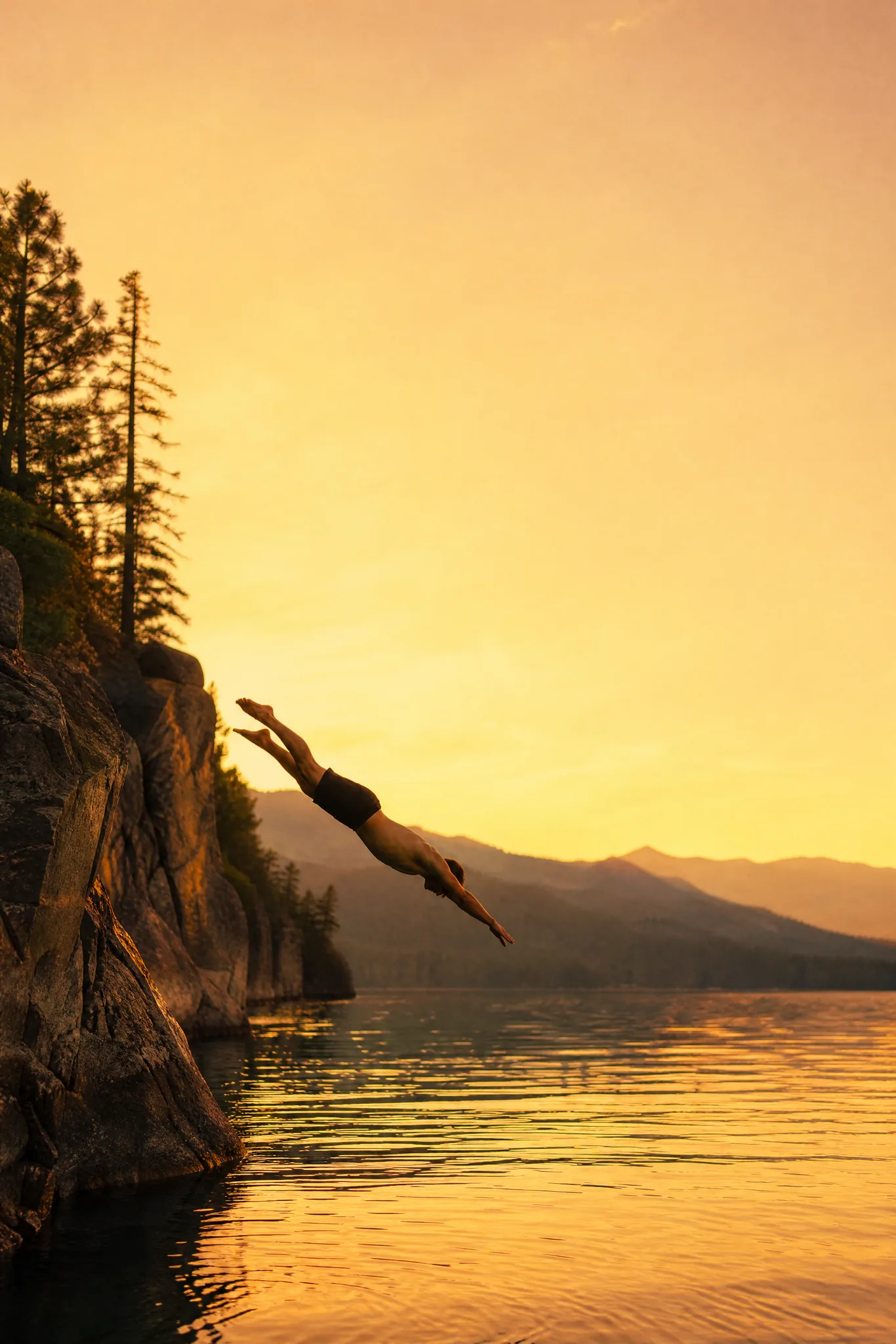 Grok Imagine Image 2: Dive with Sky Space Cliff diver in mid-air above a golden sunset lake with a broad band of open sky above
